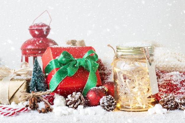 Antique lamp, gift and glass jar with lights while it snows