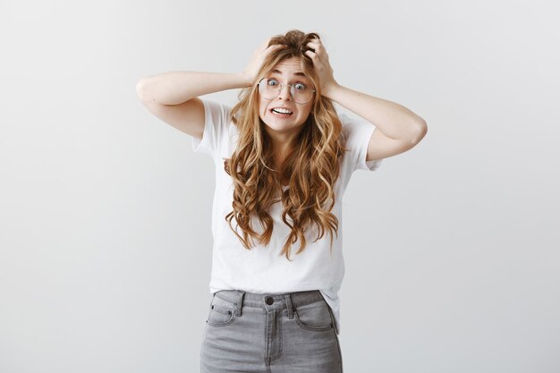 Anxious and alarmed blond girl in panic stare shocked