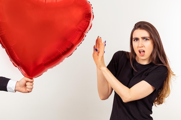 Anxious lady doesn't want to take balloon from the man