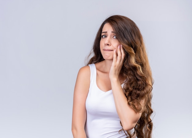 Anxious young beautiful girl with hand on cheek  with copy space