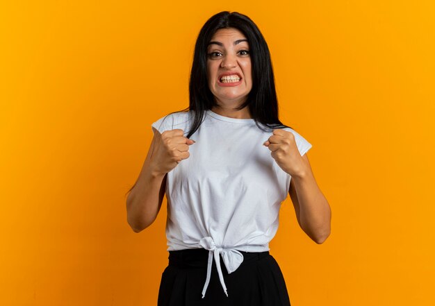 Anxious young caucasian woman keeps fists