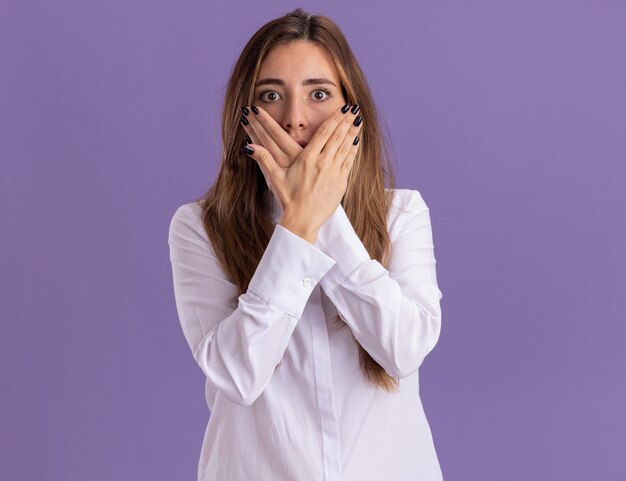 Anxious young pretty caucasian girl crosses hands and holds in front of face isolated on purple wall with copy space