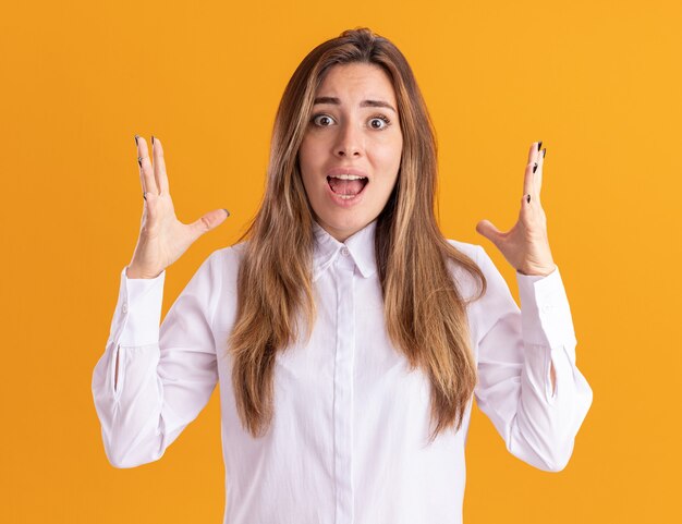 Anxious young pretty caucasian girl stands with raised hands