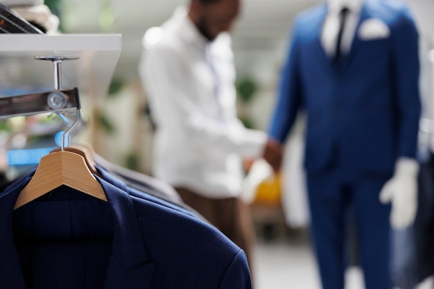 Free photo apparel hanging on rack in shopping mall clothing section