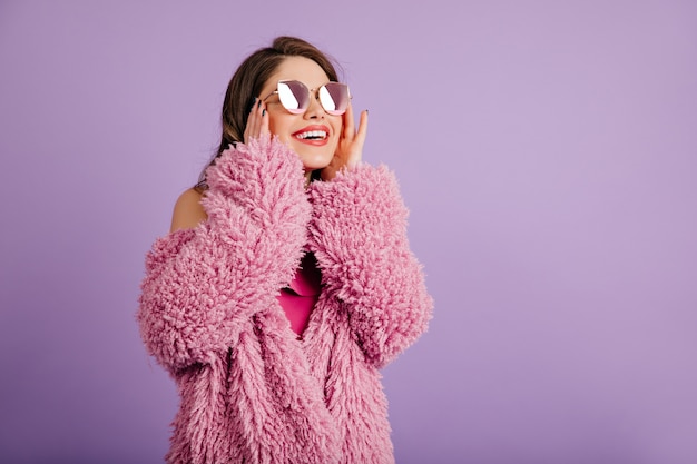 Appealing woman in eco coat looking up