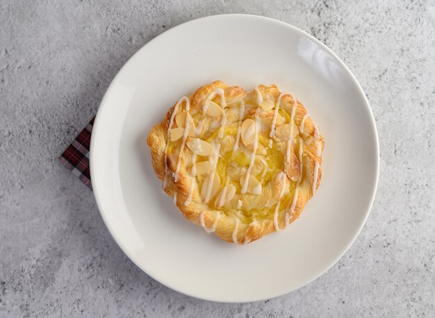 Appetizer of almond twist bread on white dish