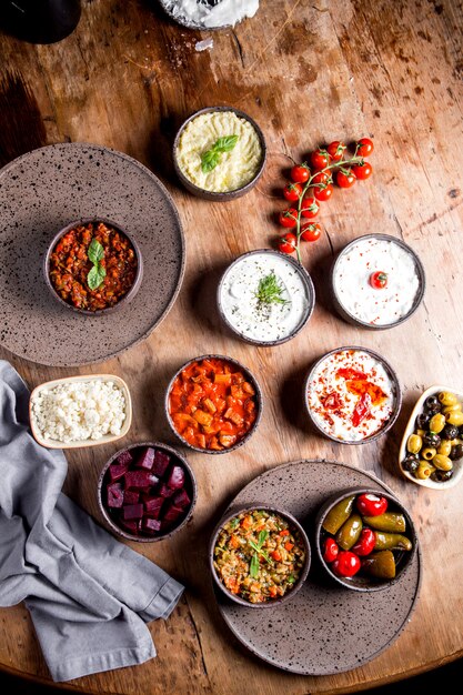 Appetizer set with salads, olives, pickles, chopped beetroot, tomatoes, cheese and yogurt