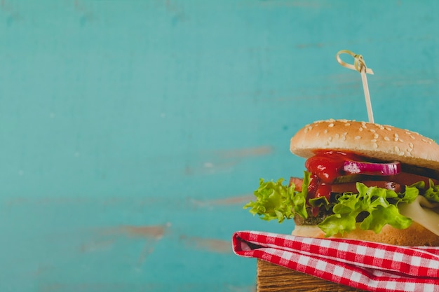Appetizing burger on tablecloth