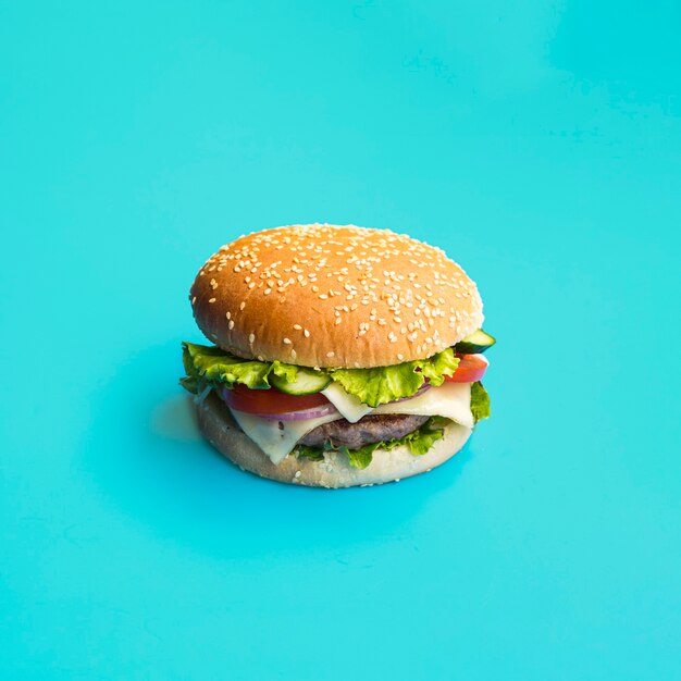 Appetizing hamburger on blue background