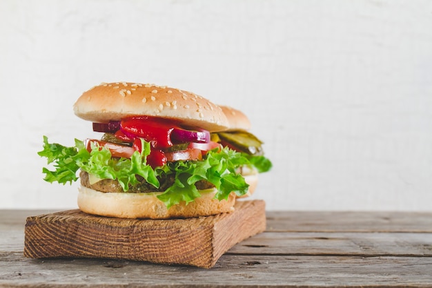 Appetizing hamburgers with tomato and lettuce