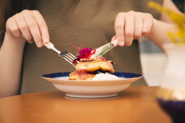 Appetizing pancakes decorated with berries and flowers