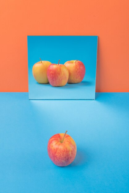 Apple on blue table isolated on orange