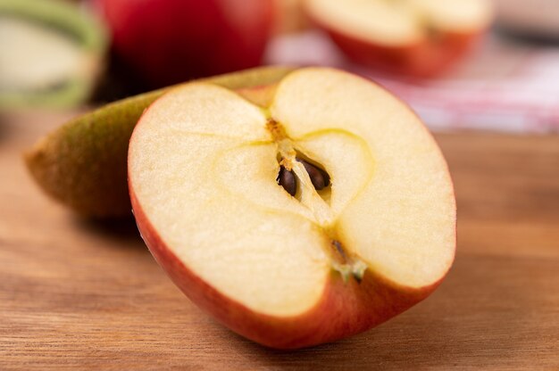 Apple cut in half on a wooden table