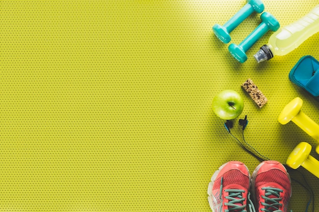 Free photo apple and energy bar near sports stuff