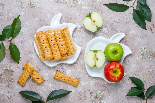 Apple puff pastry cookies in apple shape plate with fresh apples