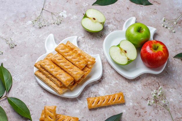 Apple puff pastry cookies in apple shape plate with fresh apples