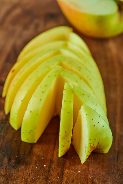 Apple slices on wooden cutting board, close up. 