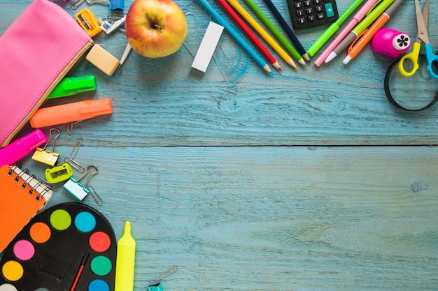 Apple and stationery on tabletop