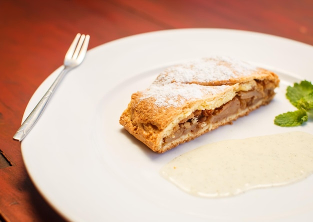 Apple strudel with sauce and coffee