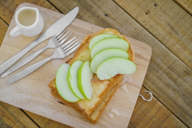 Apple with bread served on wood plate