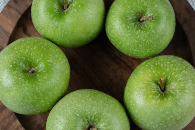 Apples isolated on a rustic wooden platter