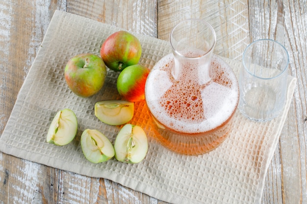 Apples with juice on wooden and kitchen towel