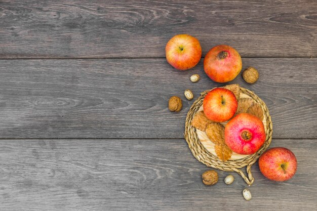 Apples with pomegranate on table 