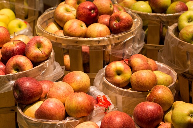 Apples in wooden containers under the lights