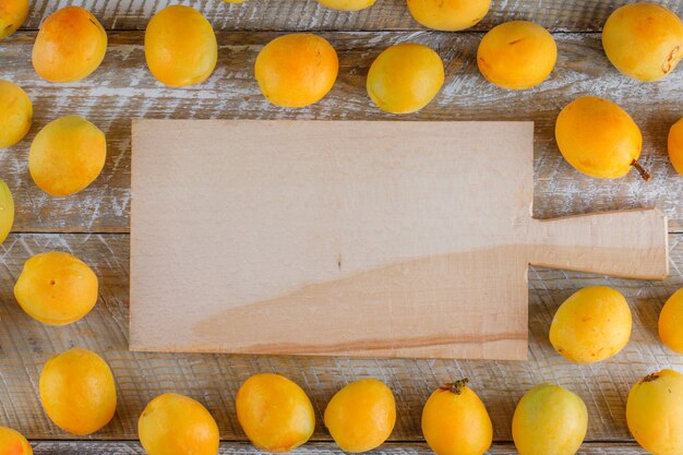 Apricots flat lay on wooden and cutting board