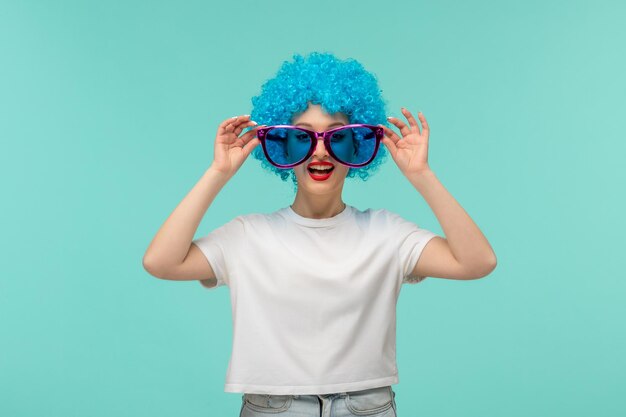 April fools day clown girl happy hands touching big pink blue sunglasses funny costume blue hair