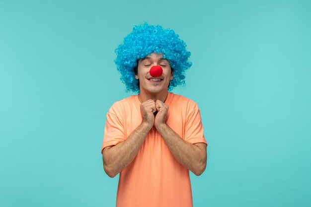 April fools day guy clown happy excited fists together under chin blue hair funny red nose