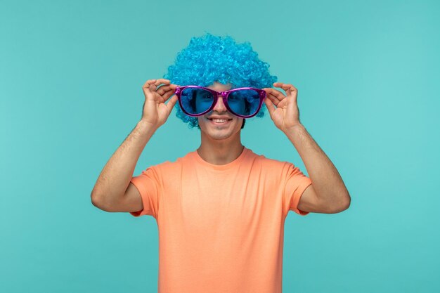 April fools day guy clown happy smiling blue hair s funny touching corner of pink big sunglasses