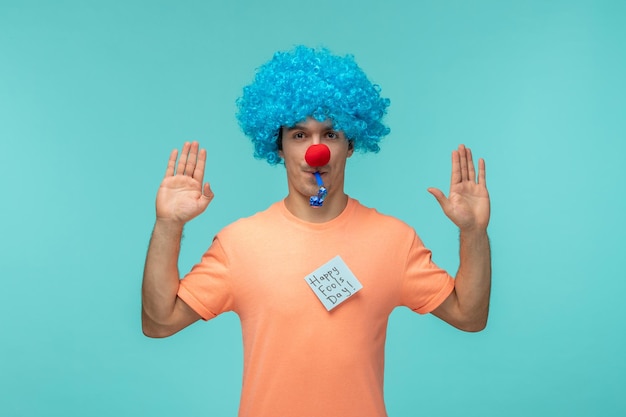 Free photo april fools day guy red nose clown funny blue whistle blue hair blue post it sticker hands up