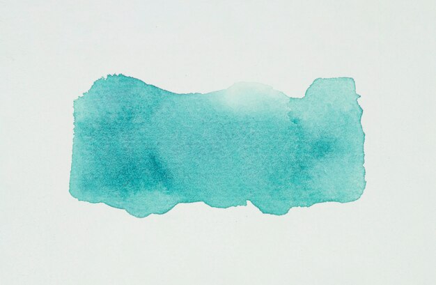 Aquamarine blot of paints on white paper