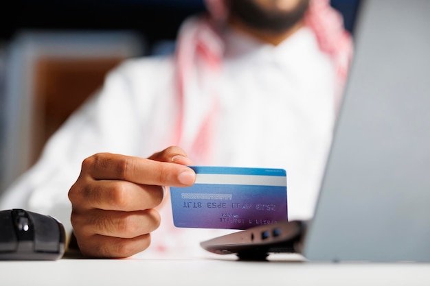 Free photo arab businessman shops with credit card