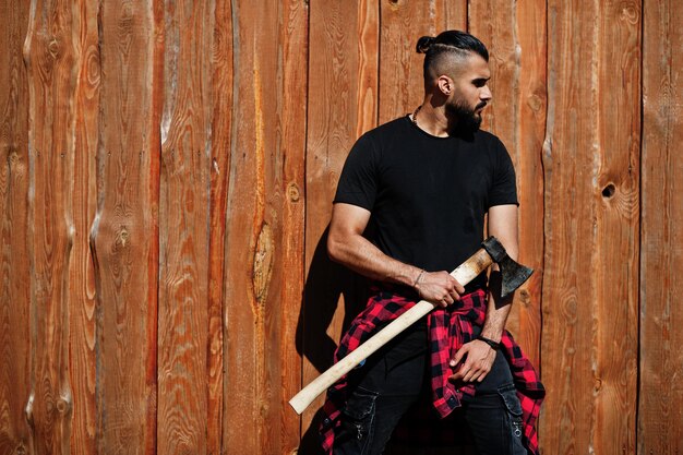 Arab hipster beard man lumberjack hold axe