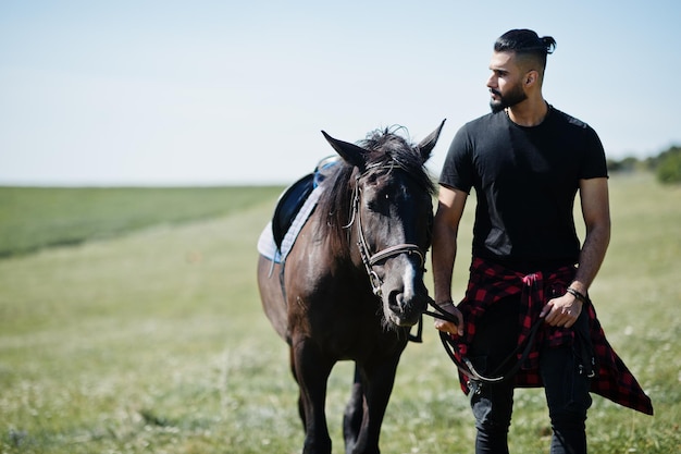 Arab tall beard man wear in black with arabian horse