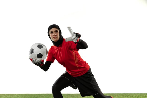 Arabian female goalkeeper on white studio wall