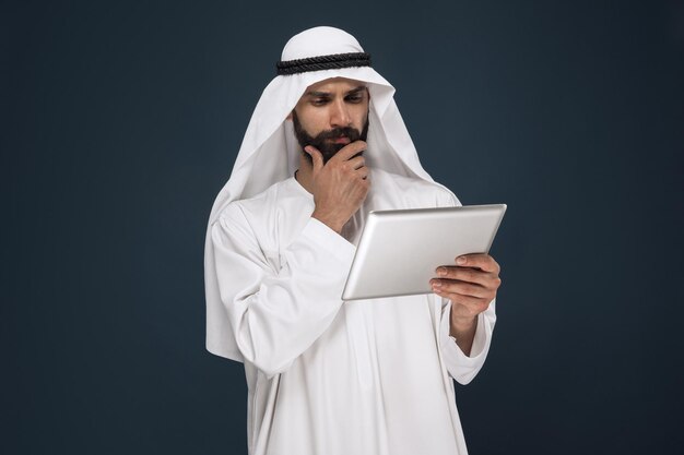 Arabian saudi businessman on dark blue studio background