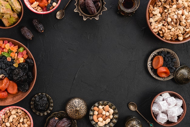 Arabic delicious dried fruits; nuts; lukum; baklava on black backdrop