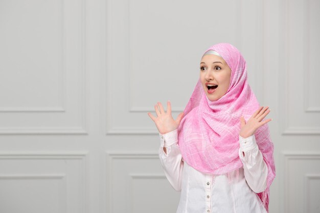 美しいピンクのヒジャーブで覆われたアラビアの女の子は、友達に会えてうれしいかわいい若いイスラム教徒の女性