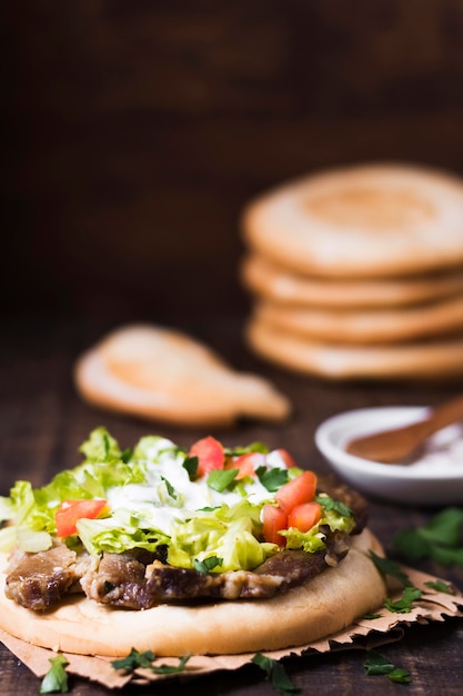 Arabic kebab sandwich in pita bread blurred background