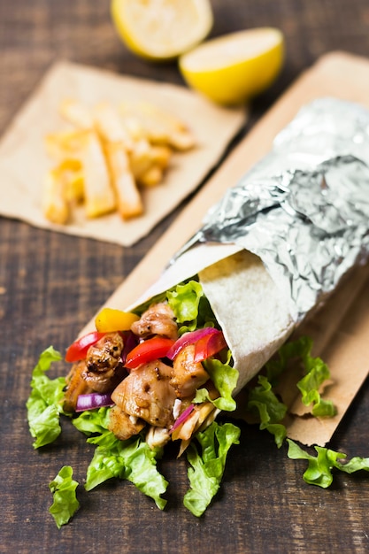 Free photo arabic kebab sandwich wrapped in aluminium foil