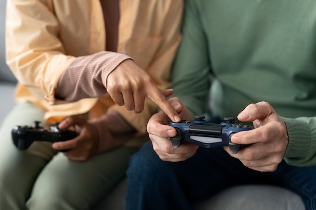 Arabic woman and senior man playing videogames