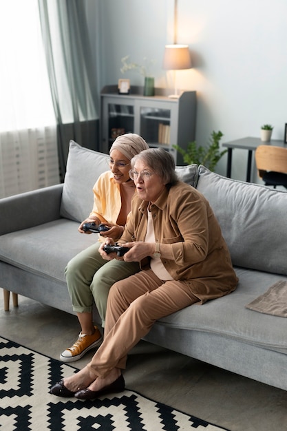 Arabic woman and senior woman playing videogames