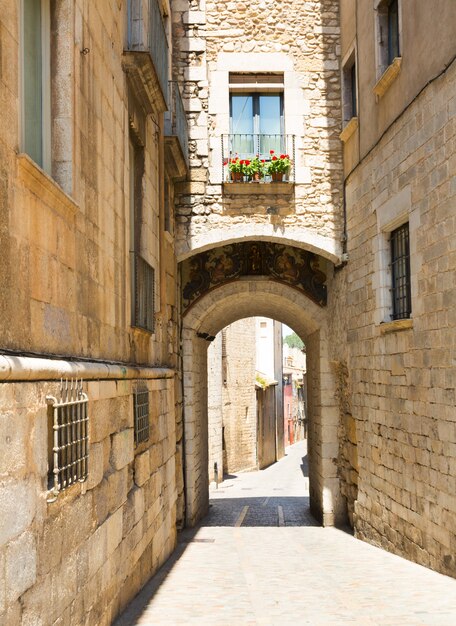 Arch over old narrow street of  city.  Girona