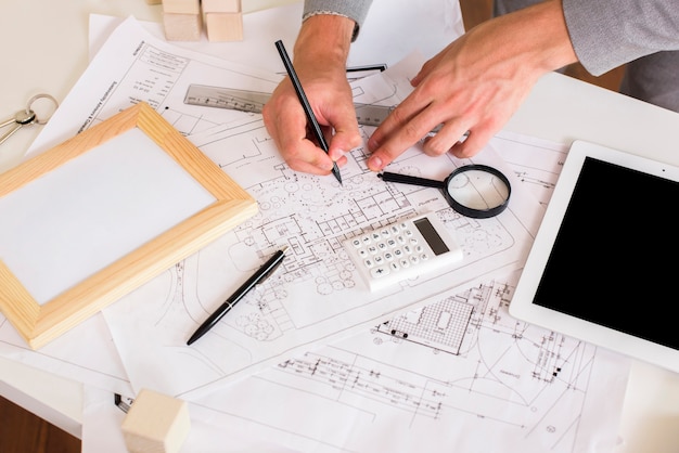Architect drawing a plan on paper mockup
