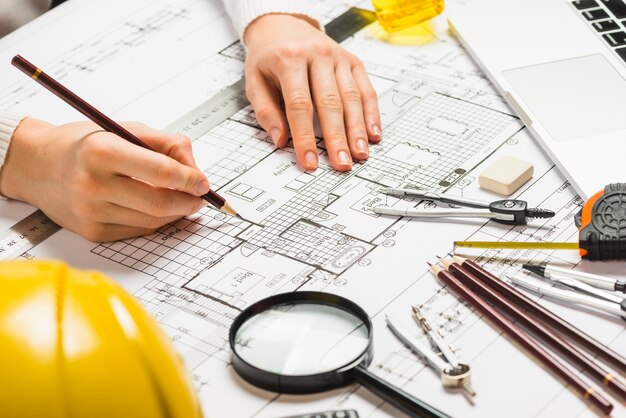 Free photo architect drawing plan with pencil