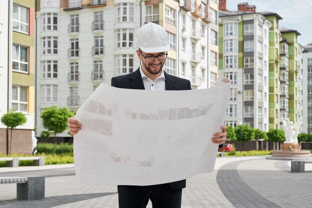 Architect in hardhat looking at construction projects