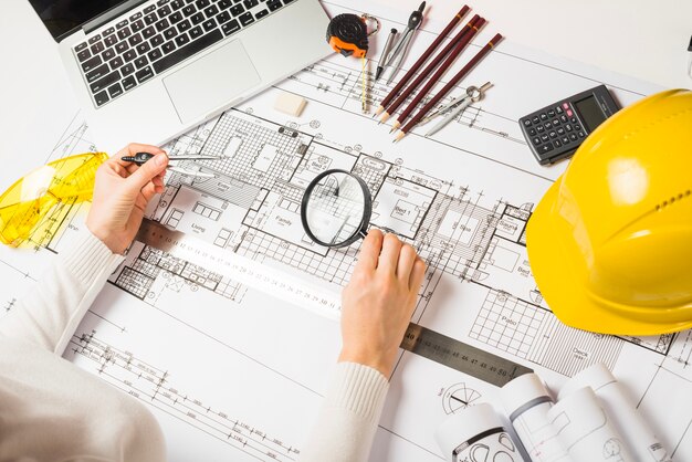 Architect making plan with loupe